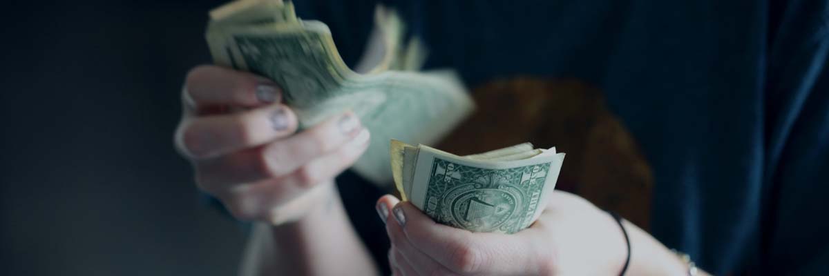 How Much Money to Bring to Vegas (2024 Budget) 3 counting money - how much should you bring to las vegas