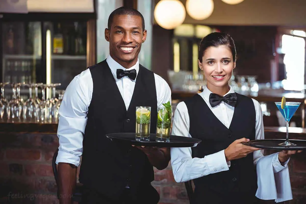 Cocktail waiter and waitress serve free drinks in a Las Vegas casino.