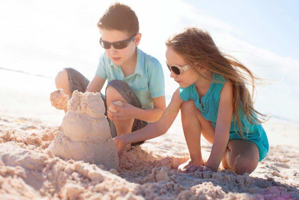 Kids building sand castle on beach in San Diego. San Diego vs. Las Vegas: Activities for Kids