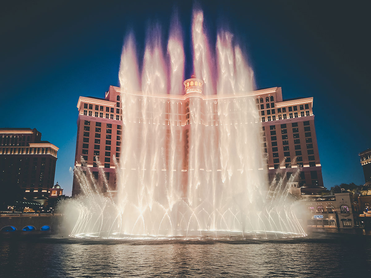 The Bellagio Fountain erupts at night in front of the Bellagio Hotel on the Las Vegas Strip.