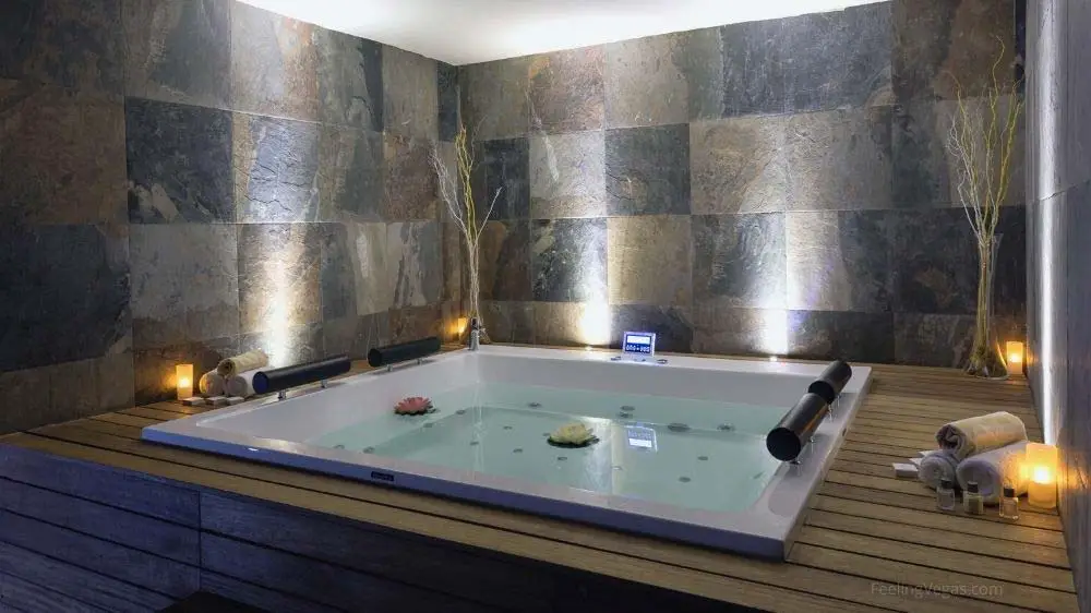 A large jacuzzi tub in a hotel room.