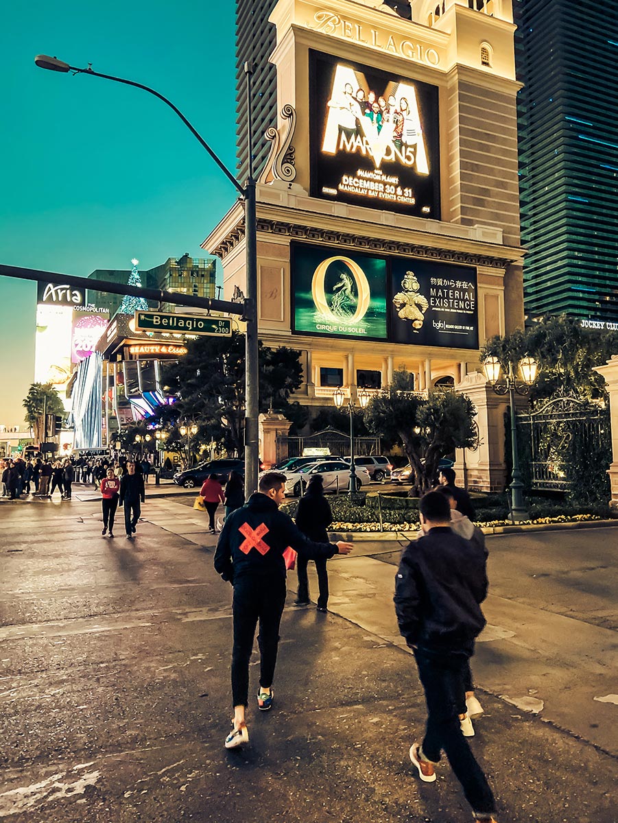 Pedestrians walking on the Las Vegas Strip at night.