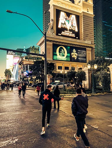 Pedestrians walking on the Las Vegas Strip at night.