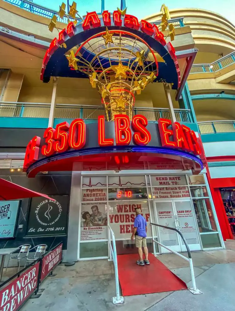 Man checking his weight on the scale outside of the Heart Attack Grill in Las Vegas