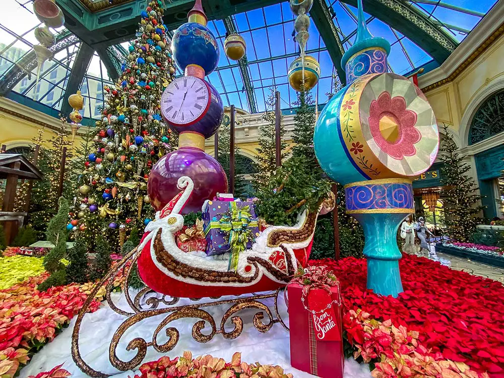Santa's sleigh and Christmas tree on display in the Bellagio Conservatory.
