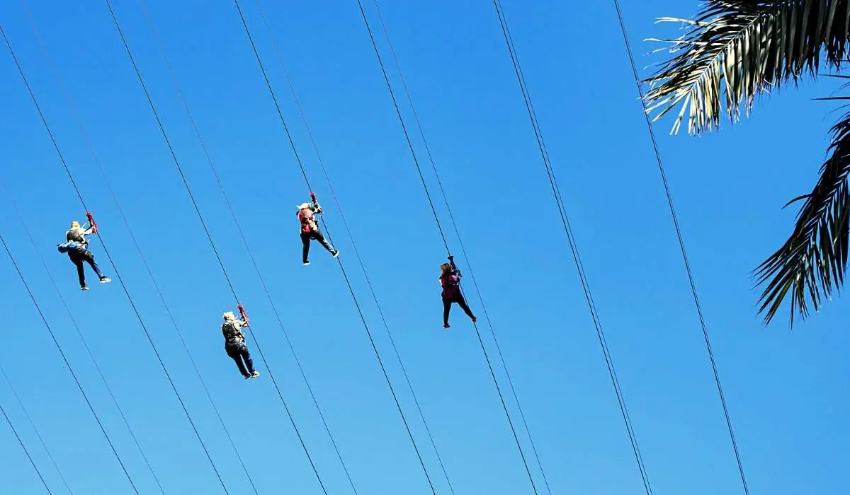 Riders flying overhead at the Fly LINQ zipline at the Linq Promenade in Las Vegas