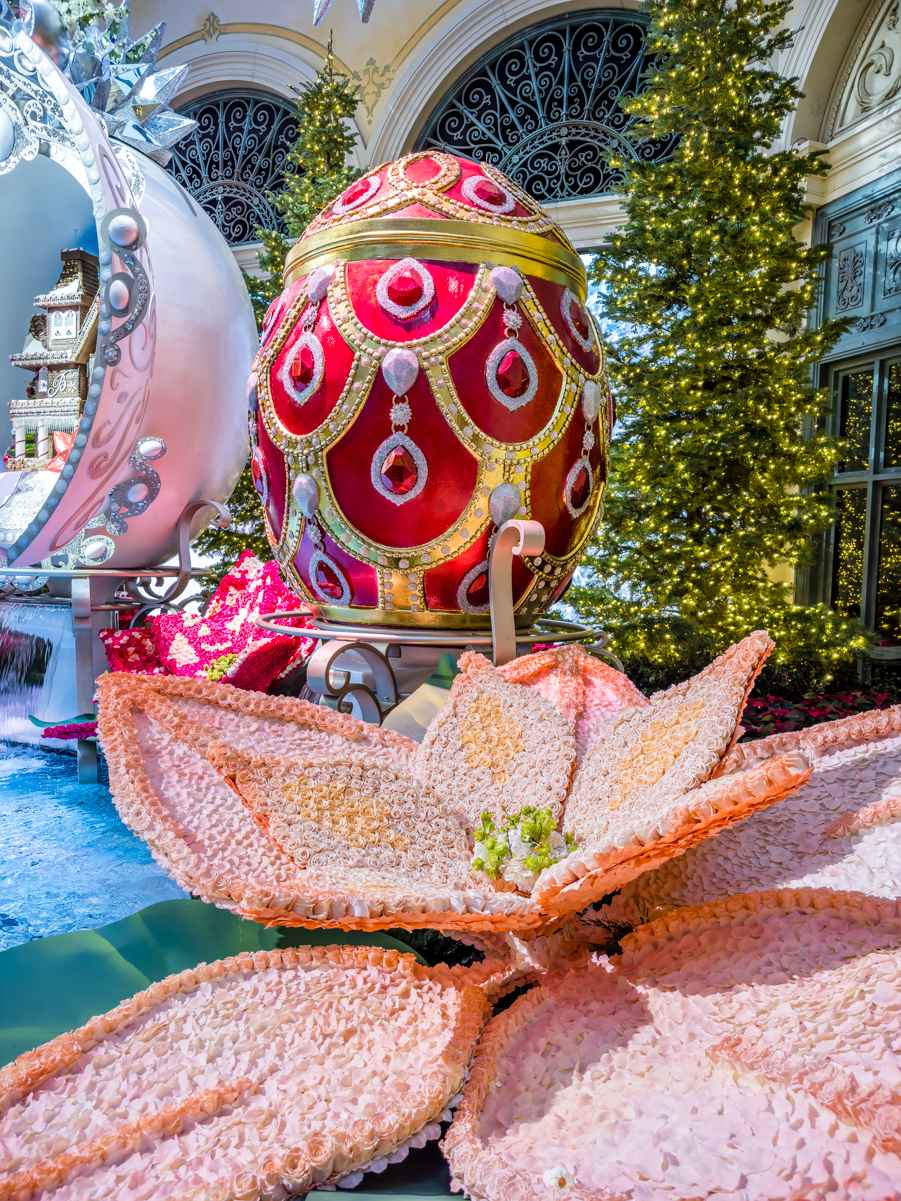 Giant poinsettias made of roses and a large, jeweled Faberge egg.