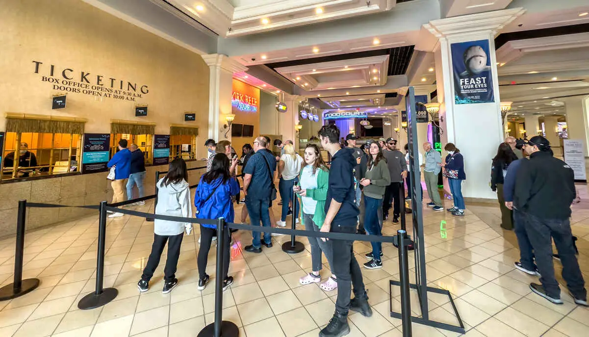 Is the Aquarium Free if You Stay at Mandalay Bay? (Shark Reef Las Vegas) 3 People standing in line to get tickets to Shark Reef at Mandalay Bay Las Vegas